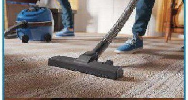 Housekeeping staff vacuuming a carpet